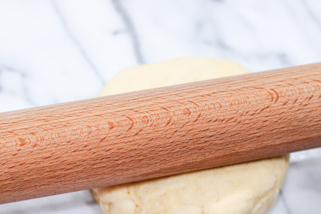 Rolling pin on round of pie dough. 