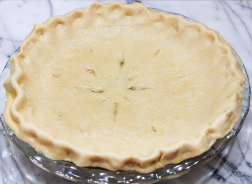 Pie with raw crust on top.  Slits cut in top for venting. 