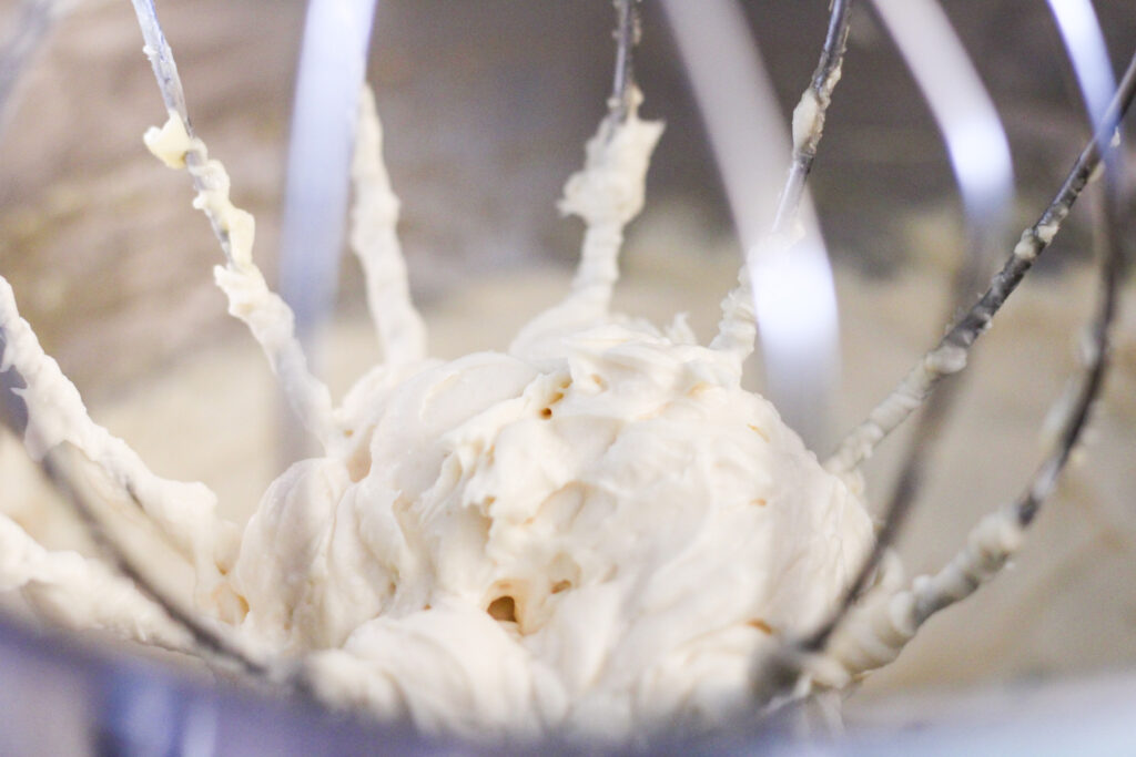 Maple cream cheese frosting on whisk 