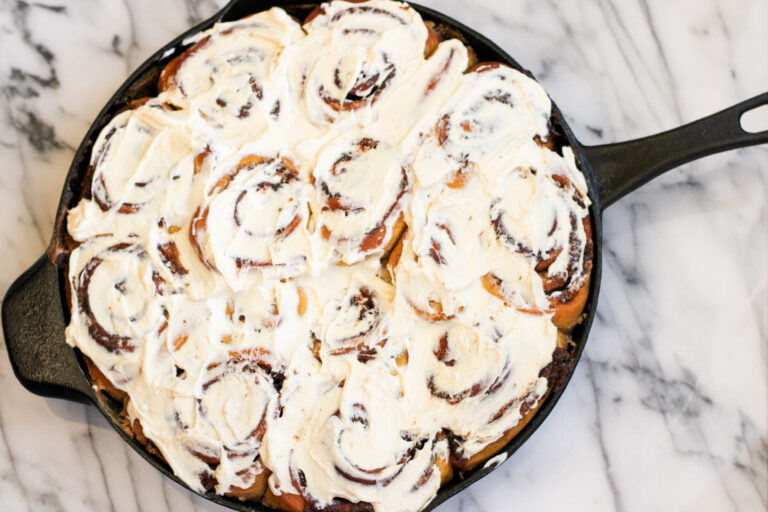 Baked and frosted Pumpkin Spice Cinnamon Rolls in Cast Iron Pan. #castironcooking #pumpkinspice #autumncooking