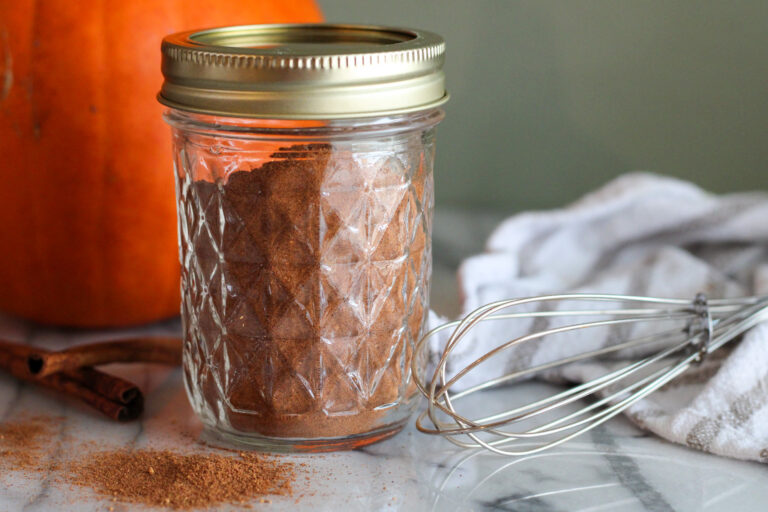 Pumpkin pie spice in glass jar with lid on.