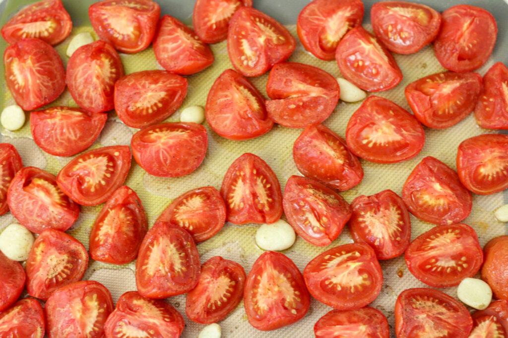 Tray with roasted tomatoes, garlic, and olive oil.