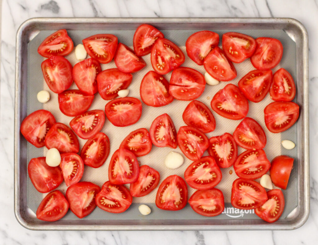 Tray with tomatoes and garlic for roasting.