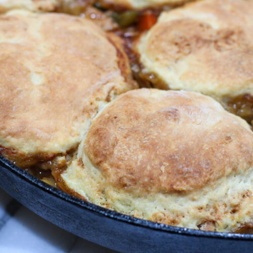 Cooked chicken and biscuits in cast iron pan
