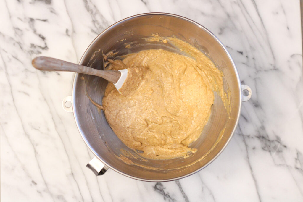 Pumpkin Pancake batter in metal bowl with spatula.