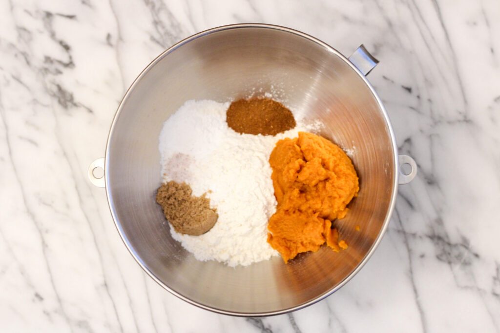 Pumpkin pancake ingredients in metal bowl.