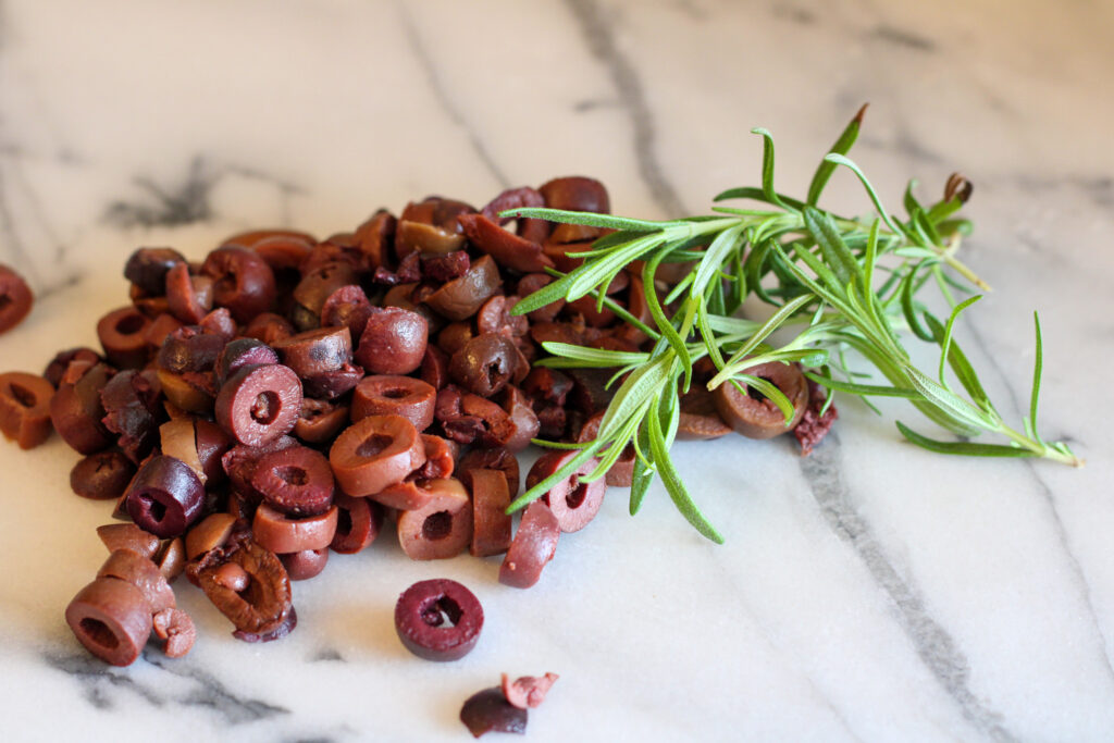 Sliced kalamata olives and rosemary sprigs