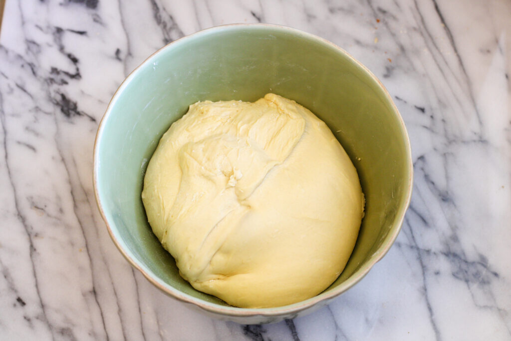 Green bowl with bread dough. 