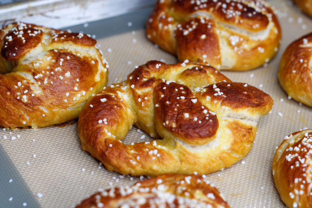 Sourdough soft pretzels on baking sheet. 
