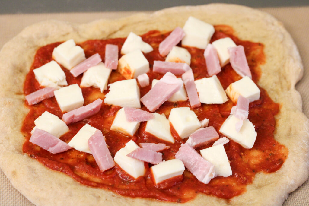 Assembled, but uncooked homemade pizza. 