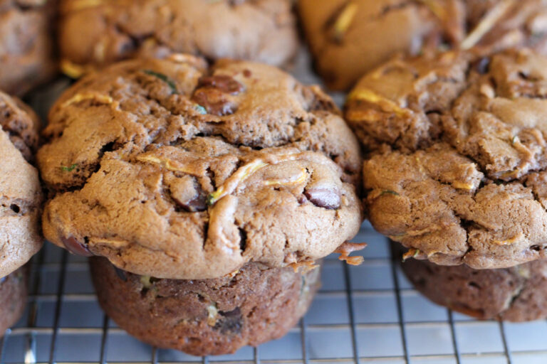 Closeup of Sourdough chocolate chip zucchini muffins on cooling rack.