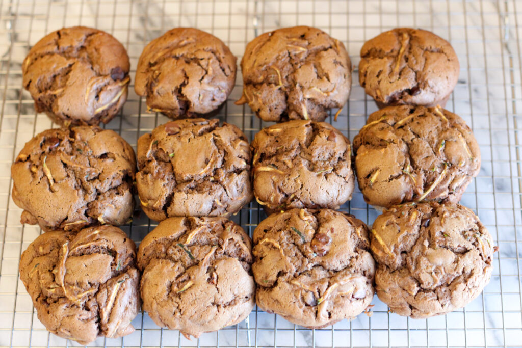 Sourdough chocolate chip zucchini muffins on cooling rack.