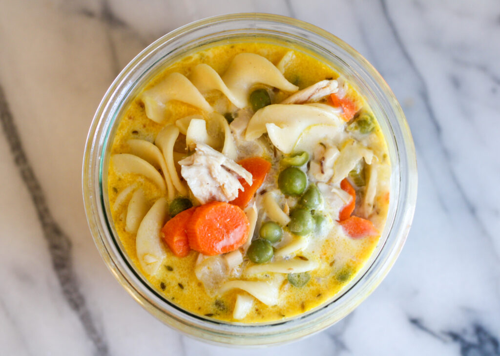 bowl of creamy chicken soup on marble countertop