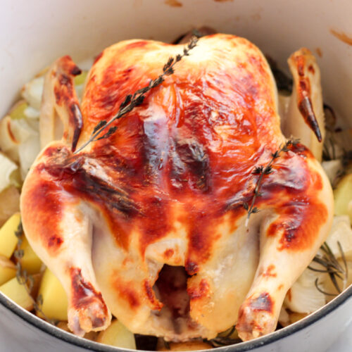 Roasted Chicken in dutch oven with potatoes and onions.