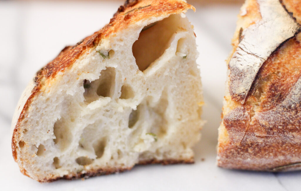 Closeup of sourdough herb bread sliced.