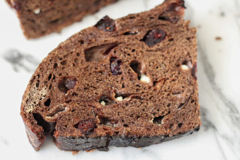 Cut chocolate bread loaf with cranberries and white chocolate chips.