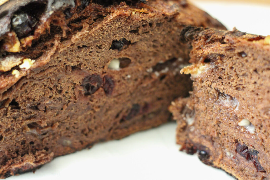 Cut chocolate bread loaf with cranberries and white chocolate chips.