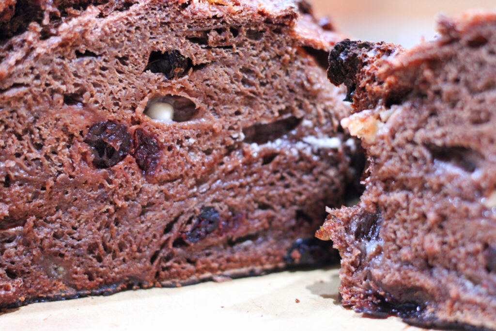 Cut chocolate bread loaf with cranberries and white chocolate chips.