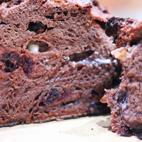 Cut chocolate bread loaf with cranberries and white chocolate chips.