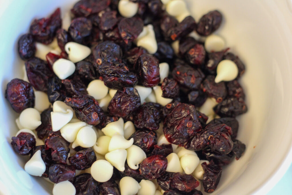 Bowl of cranberries and white chocolate chips.