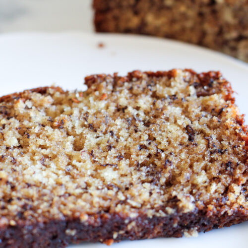 Slice of sourdough banana bread on white plate.
