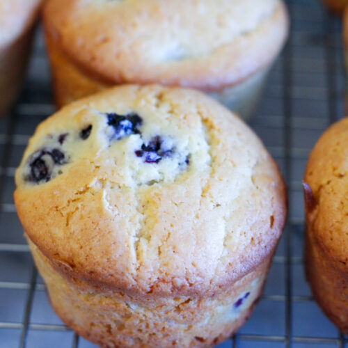 Blueberry muffins on cooling rack.