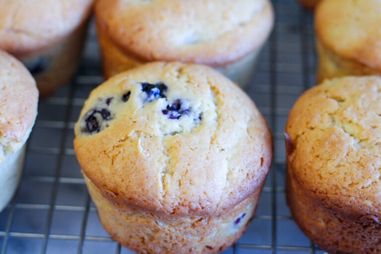 Blueberry muffins on cooling rack.