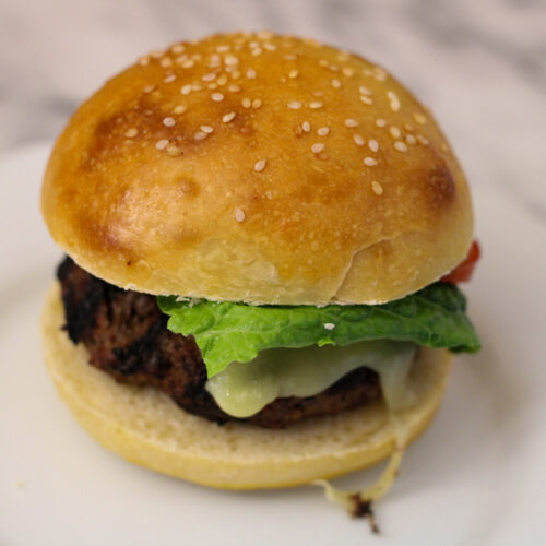 Hamburger on white plate.
