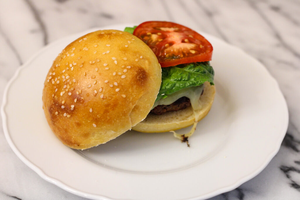 Hamburger on white plate.