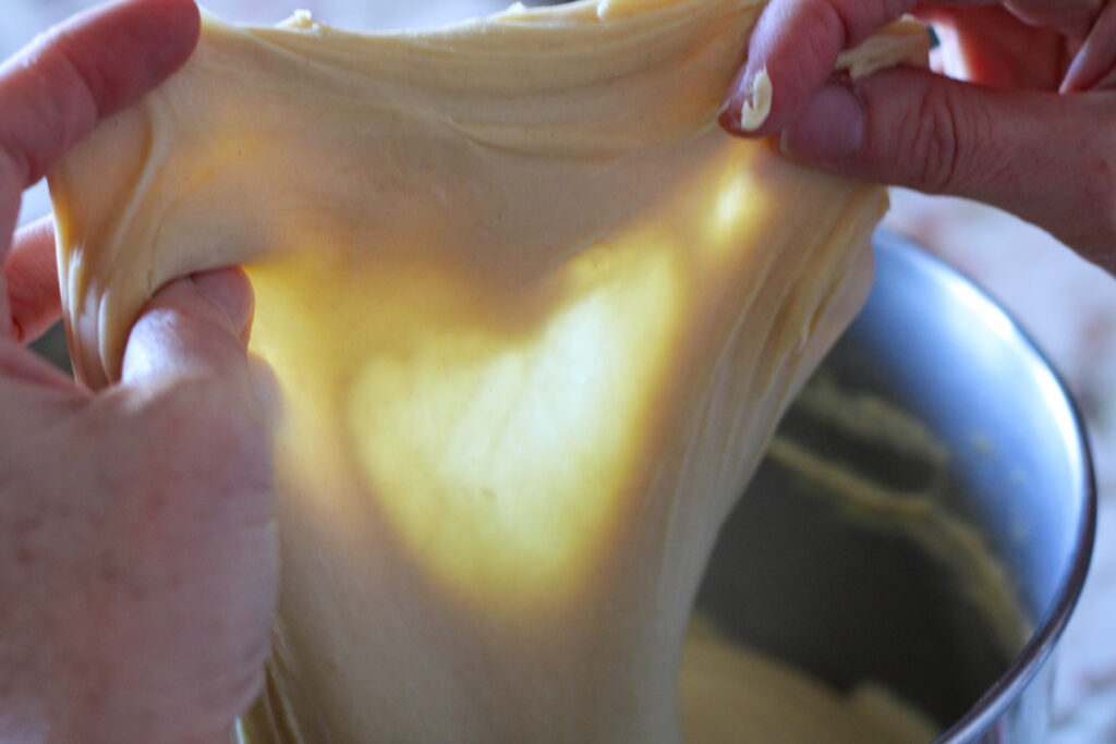 Dough stretched to point of window pane.